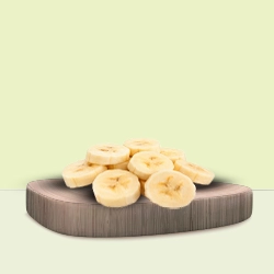 Sliced banana rounds arranged neatly on a wooden board, perfect for a healthy snack or recipe.