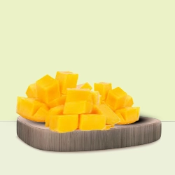 Cubed ripe mango pieces are arranged on a wooden platform, highlighting their bright yellow colour.