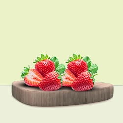 Fresh strawberries with green leaves are arranged on a wooden board, emphasising their vibrant red colour.