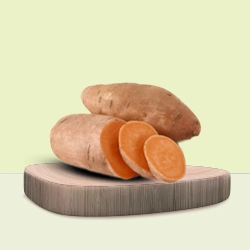 Whole and sliced sweet potatoes showcasing their rich orange colour.