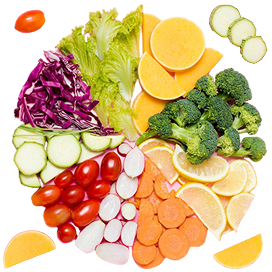 A vibrant mix of fresh vegetables and citrus fruits arranged in a colorful wheel, highlighting their natural textures and shapes.